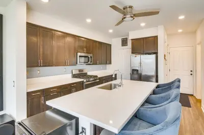 a kitchen with a white counter top and wooden cabinets at Home Theater System and Gazebo Los Angeles Getaway! in San Fernando