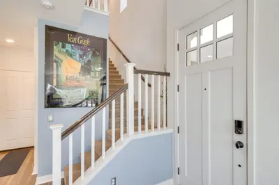 a white hallway with a white door and stairs at Home Theater System and Gazebo Los Angeles Getaway! in San Fernando