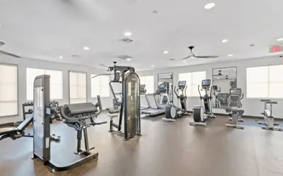 a gym with several treadmills and cardio machines at Newly Remodeled 3BR Apt | Mins to Disney | Arcade in Placentia