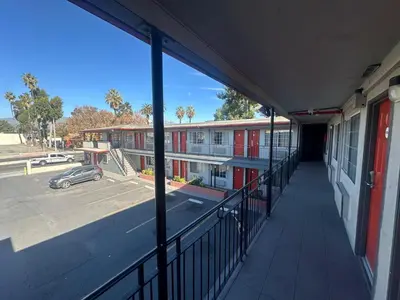an empty hallway of a school building with a parking lot at Heritage Inn in Pomona