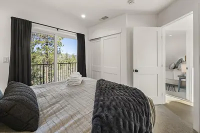 a bedroom with a bed and a large window at Skyline Summit Lodge in Big Bear Lake