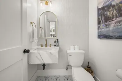 a white bathroom with a sink and a toilet at Skyline Summit Lodge in Big Bear Lake