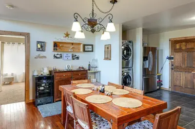 a kitchen with a wooden table and a dining room at PMC Mountainside Cabin Hit the Trails, Play Pool! in Pine Mountain Club