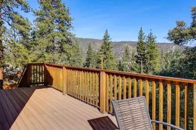a deck with two chairs and a view of the mountains at PMC Mountainside Cabin Hit the Trails, Play Pool! in Pine Mountain Club
