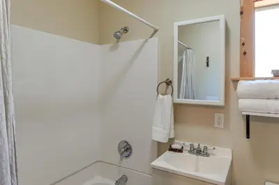 a white bathroom with a sink and a mirror at PMC Mountainside Cabin Hit the Trails, Play Pool! in Pine Mountain Club