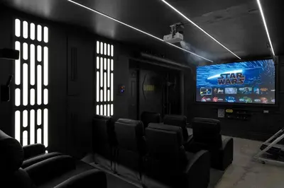 a group of chairs in a room with a television at Star Wars Retreat by OC Adventure Homes in Garden Grove