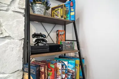 a shelf with snacks and a video camera on it at Star Wars Retreat by OC Adventure Homes in Garden Grove