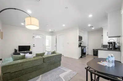 a living room with a green couch and a table at Niagara Haven Unit 103 in Burbank