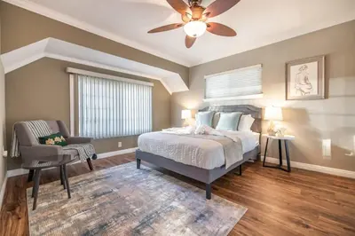 a bedroom with a bed and a ceiling fan at Marbella Lane - Charming 4BR Bungalo for Relaxing Retreat in Fullerton