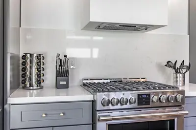 a kitchen with a stove and a counter top at Cozy Modern Haven w Soothing Ambience & Pool in Fullerton