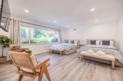 a bedroom with a king sized bed and a couch at Marbella Lane - Serene Ranch Style Home wPool in Fullerton