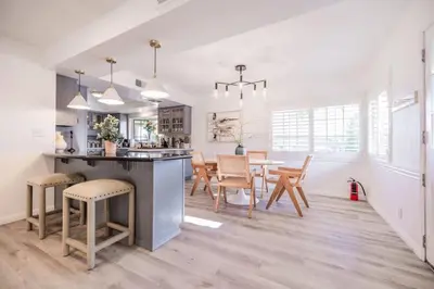 a kitchen and dining room with a table and chairs at Marbella Lane - Serene Ranch Style Home wPool in Fullerton