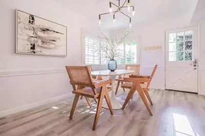 a white dining room with a table and chairs at Marbella Lane - Serene Ranch Style Home wPool in Fullerton