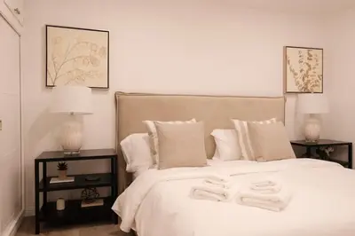 a bedroom with a bed with two towels on it at Marbella Lane - Serene Ranch Style Home wPool in Fullerton