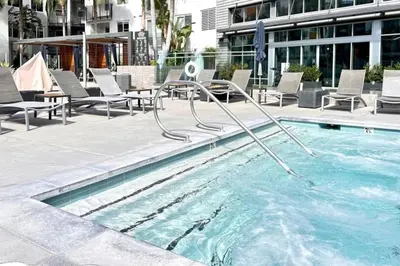 a swimming pool with a slide in a building at The Mandarin at Main Place - Free Disney Gift Gard in Orange