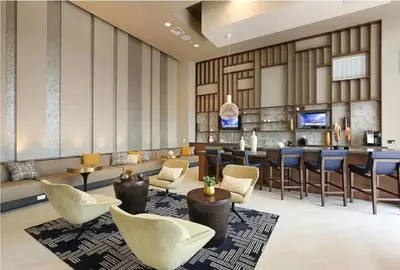 a lobby with chairs and a bar in a hotel at The Belladonna at Main Place - Disney Gift Card! in Orange