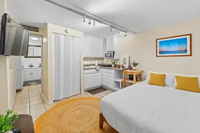 a bedroom with a large bed and a kitchen at Netflix, Stocked Kitchenette, Beach Gear in Ventura
