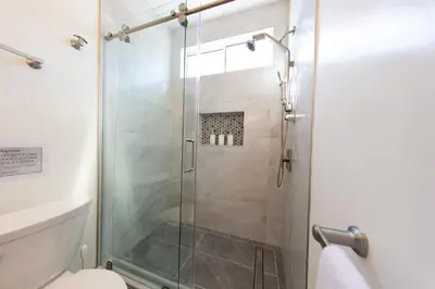 a shower with a glass door in a bathroom at Welcoming & Spacious 2-Bedroom Guest Suite in Torrance 20 Minutes from LAX in Torrance
