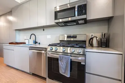 a kitchen with a stove and a microwave at Luxury 1BD Condo in LA with Rooftop City Views, Gym & Free Parking in Los Angeles