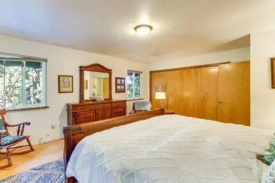 a bedroom with a bed and a dresser and a mirror at Quiet Home Less Than 1 Mi to Lake Gregory and Dtwn Crestline in Crestline