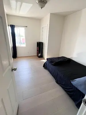 an empty room with a bed and a window at Soul in Los Angeles close to Downtown in Los Angeles