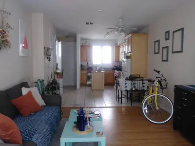 a living room with a couch and a bike in it at Cozy Bungalow in Hewitt