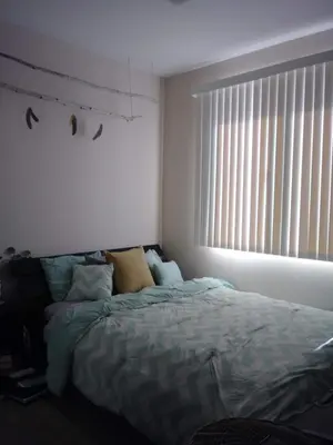 a bedroom with a bed and a large window at Cozy Bungalow in Hewitt