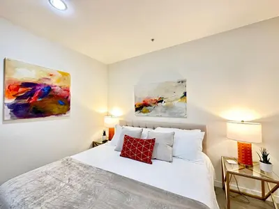 a bedroom with a bed and two paintings on the wall at The Gallery Spacious 2BD 2BA with Two King Beds in Los Angeles