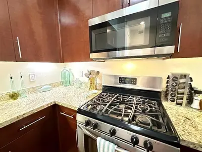 a kitchen with a stove and a microwave at 2 King Beds DTSM! Walk to Pier, Promenade & Beach in Los Angeles