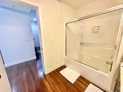 a large glass shower in a room with wood floors at Spacious 2 BD with 2 King Beds Walk to Pier & Beach in Los Angeles