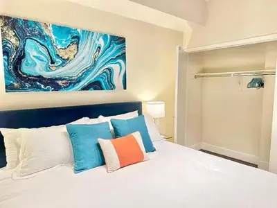a bedroom with a white bed with colorful pillows at Spacious 2 BD with 2 King Beds Walk to Pier & Beach in Los Angeles