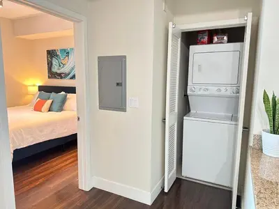 a small bedroom with a bed and a small refrigerator at Spacious 2 BD with 2 King Beds Walk to Pier & Beach in Los Angeles
