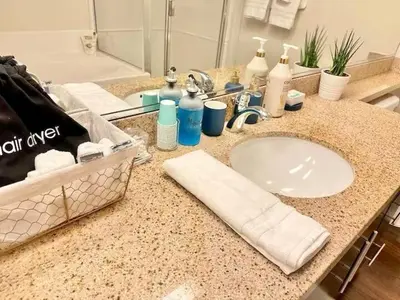 a bathroom counter with a sink and a mirror at Spacious 2 BD with 2 King Beds Walk to Pier & Beach in Los Angeles