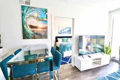 a living room with a bed and a glass table at 2 KING BEDS Walk PIER BEACH and 3rd St PROMENADE in Los Angeles