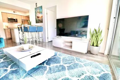 a living room with a large television and a rug at 2 KING BEDS Walk PIER BEACH and 3rd St PROMENADE in Los Angeles