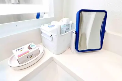 a bathroom counter with a mirror and toiletries on it at 2 KING BEDS Walk PIER BEACH and 3rd St PROMENADE in Los Angeles