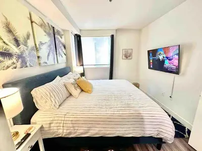 a bedroom with a large bed and a large window at 2 KING BED SUITE WALK to BEACH,PIER, PROMENADE in Los Angeles