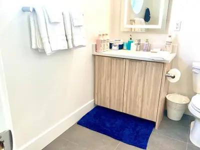 a bathroom with a sink and a blue rug at 2 KING BED SUITE WALK to BEACH,PIER, PROMENADE in Los Angeles