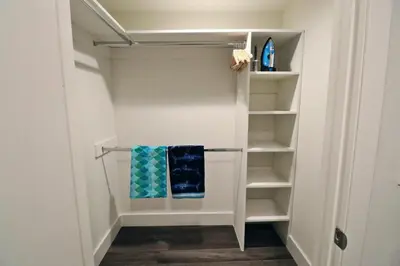 a walk in closet with two towels on the shelves at 2 KING BED LUXURY WALK to BEACH, PIER & PROMENADE in Los Angeles