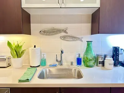 a kitchen counter with a sink and a fish on the wall at 5 Star Location with Open City Views 2BD 2BA with King Beds in Los Angeles