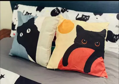 a group of pillows with cats on a bed at Cozy Beach Haven in Los Angeles