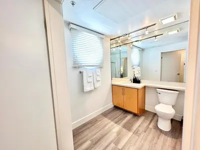 a bathroom with a toilet and a sink and a mirror at Bright 2 Bed 2 Bath with Views Walk to the Beach DTSM in Los Angeles