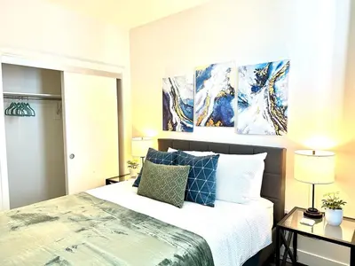 a bedroom with a bed and two paintings on the wall at Bright 2 Bed 2 Bath with Views Walk to the Beach DTSM in Los Angeles