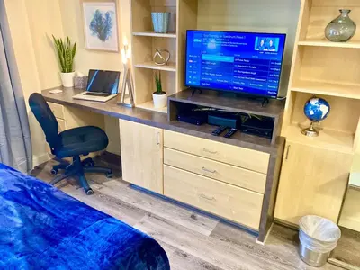 a bedroom with a desk with a television and a chair at Fully Equipped DTSM Studio, Blocks to Ocean & Pier in Los Angeles
