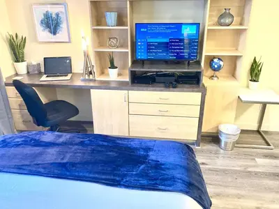 a bedroom with a desk with a computer and a television at Fully Equipped DTSM Studio, Blocks to Ocean & Pier in Los Angeles