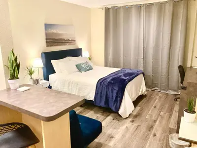 a bedroom with a bed and a table and a desk at Fully Equipped DTSM Studio, Blocks to Ocean & Pier in Los Angeles