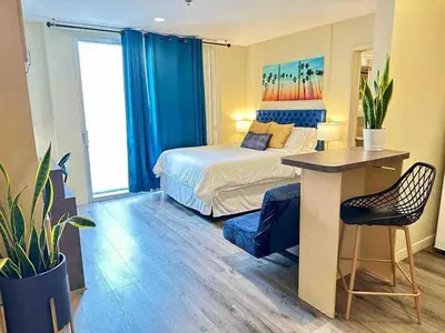 a bedroom with a bed and a table and a desk at Heart of DT SM Studio, Walk To Beach & Pier in Los Angeles