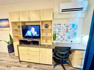 an office with a desk with a television and a chair at Heart of DT SM Studio, Walk To Beach & Pier in Los Angeles