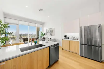 a large kitchen with a stainless steel refrigerator at Marbella Lane - Panoramic Splendid Ocean Views in Long Beach