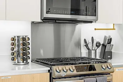 a kitchen with a stove and a microwave at Marbella Lane - Panoramic Splendid Ocean Views in Long Beach